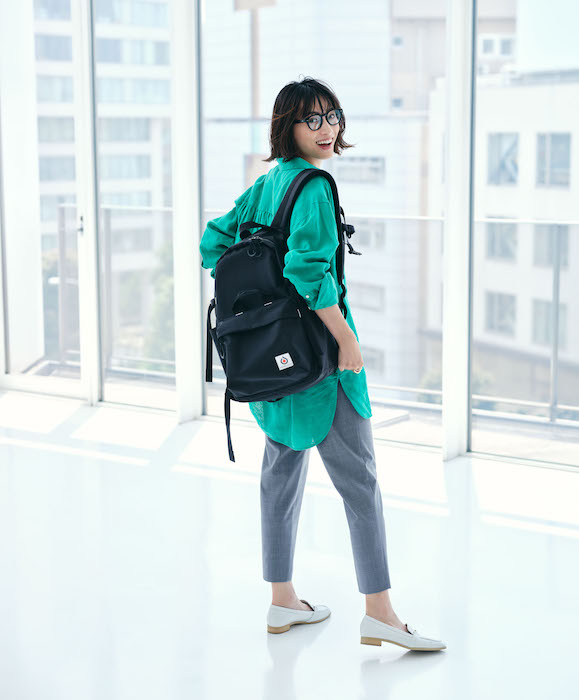 キャメル フリンジ マフラー x ベージュ リュック x ブラック タイツ x CONVERSE コンバーススニーカー ブラック ハイカット xネイビー ニット リブ ワンピースのレディースコーディネート一泊二日の冬旅行コーデ ベーシックカラーの大容量リュックが◎CBK